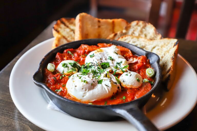 A dish of shakshuka is served in a skillet