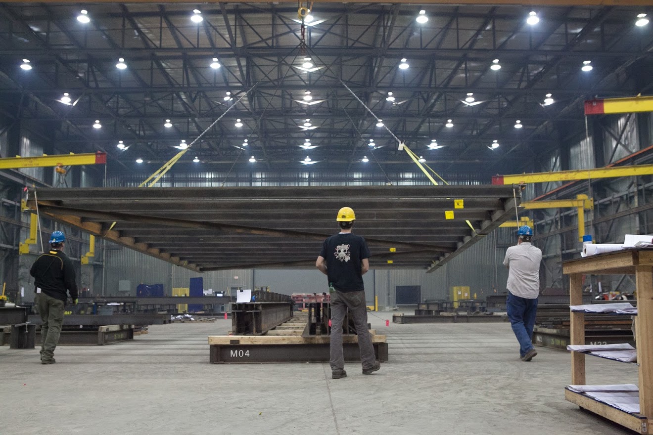 A person on a snowboard in the air jumping while grabbing the snowboard