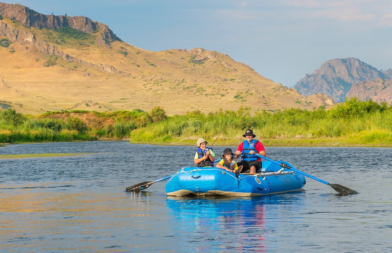A person on a snowboard in the air jumping while grabbing the snowboard