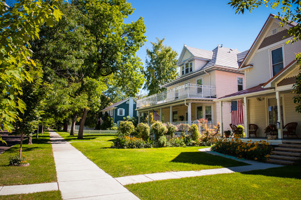 A person on a snowboard in the air jumping while grabbing the snowboard