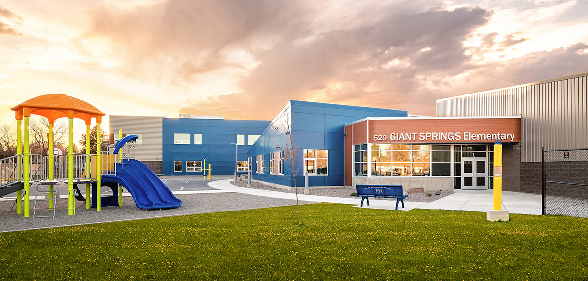 A person on a snowboard in the air jumping while grabbing the snowboard