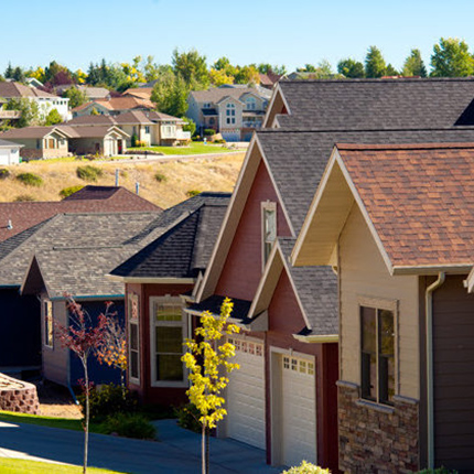 A person on a snowboard in the air jumping while grabbing the snowboard